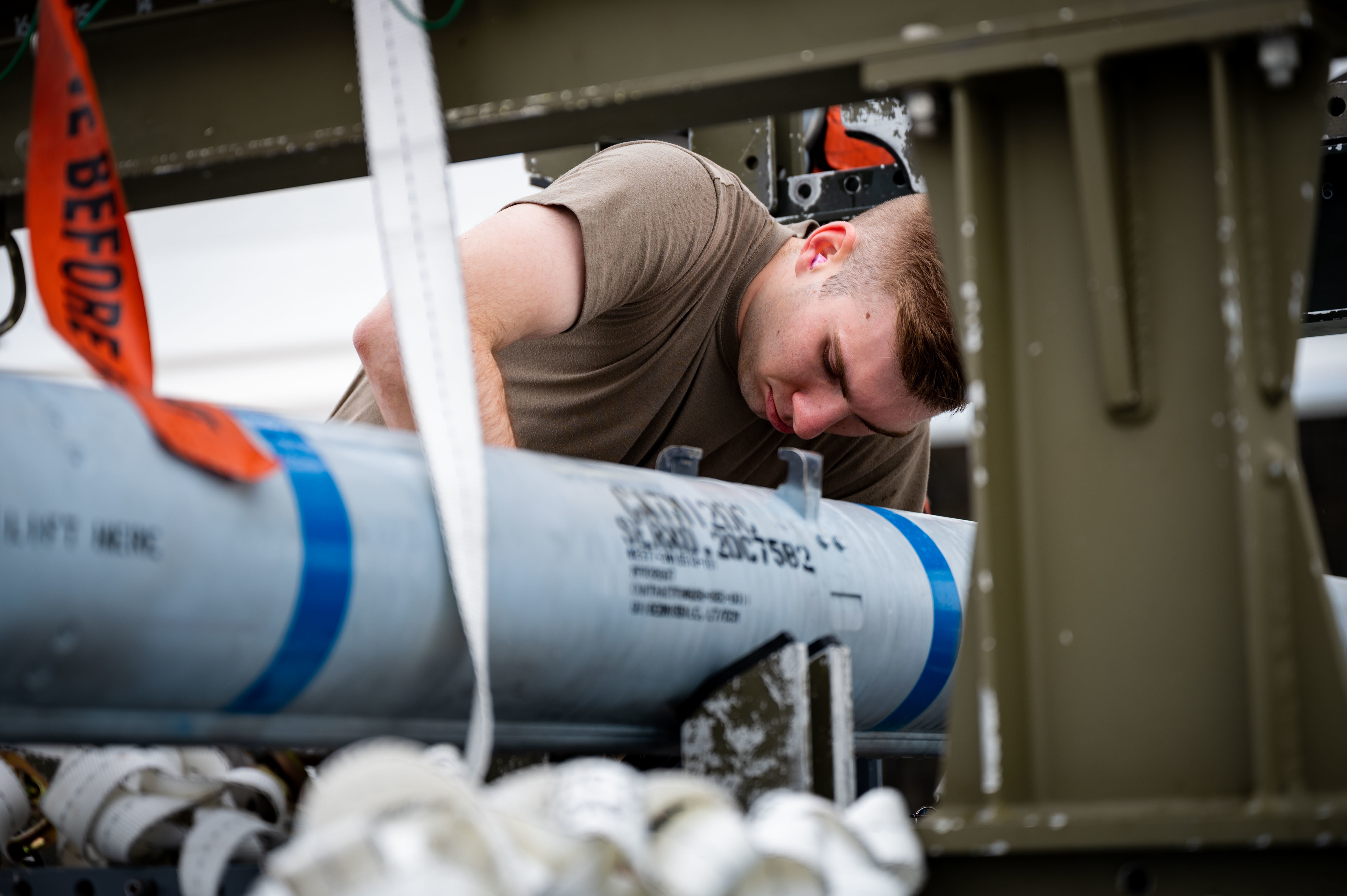 An Airmen examines a munition