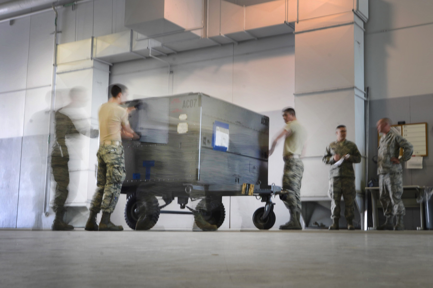 Airmen move cargo around a wearhouse