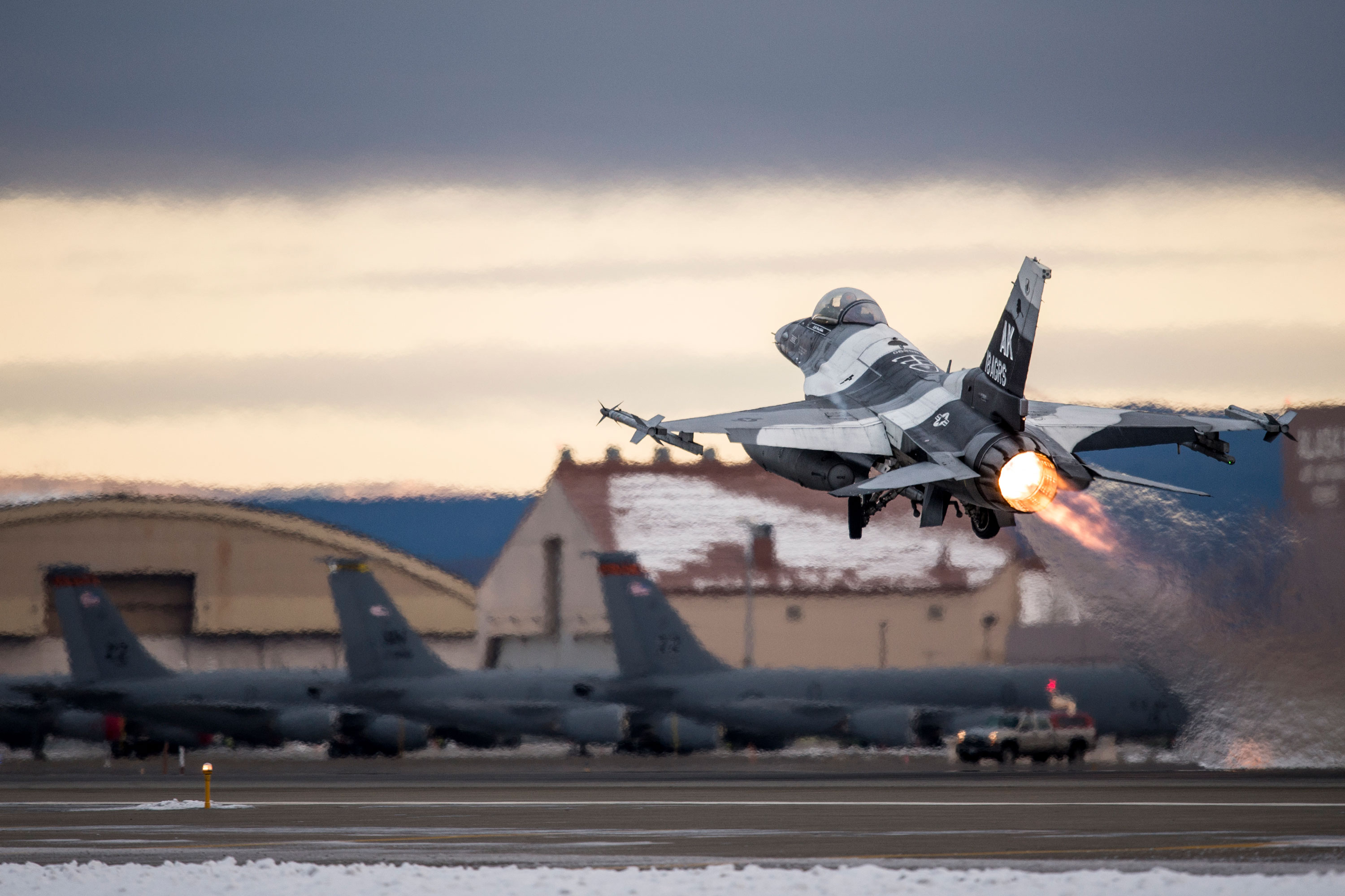 An aircraft takes off from a flightline